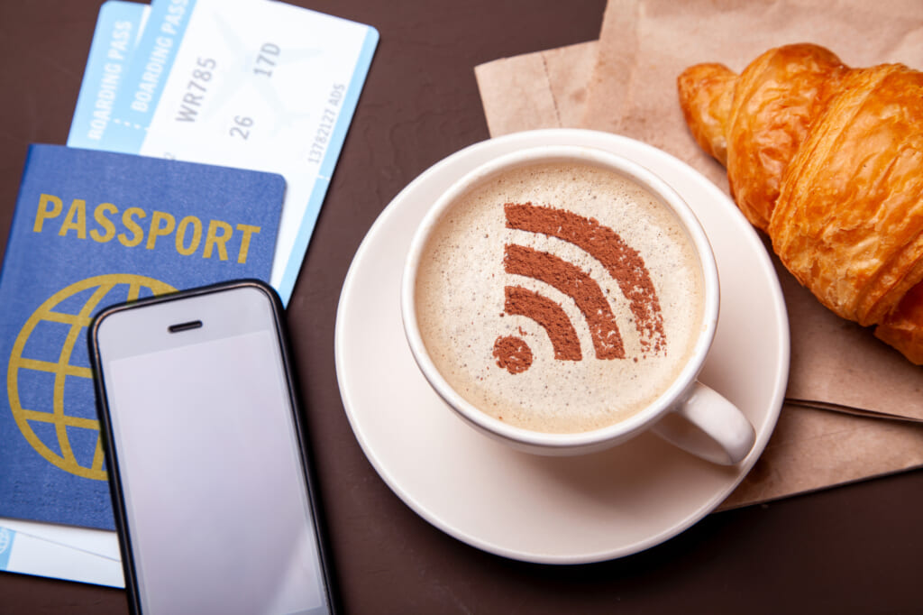 Mug of coffee with WiFi sign on the foam. Free access point to t